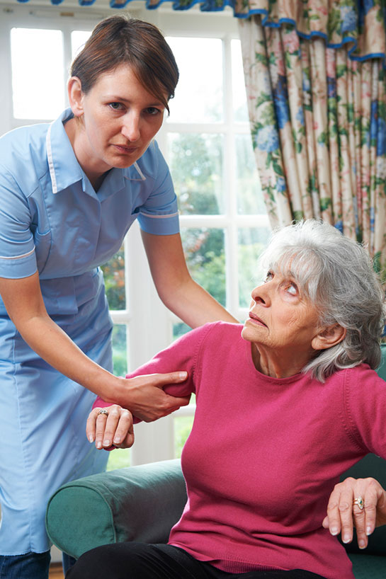 Care worker being rough with old woman